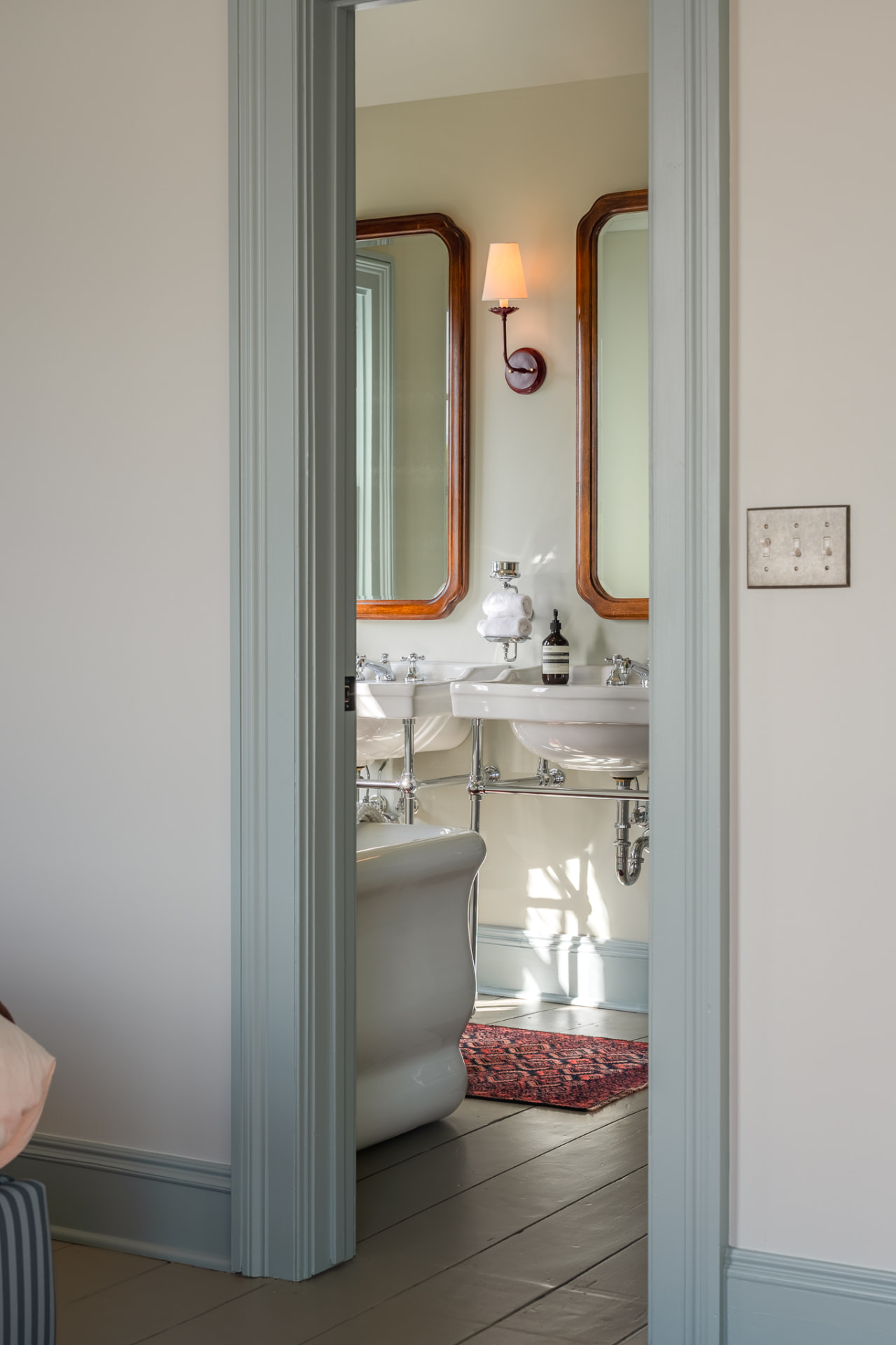 Double-sink bathroom with wooden-framed mirrors