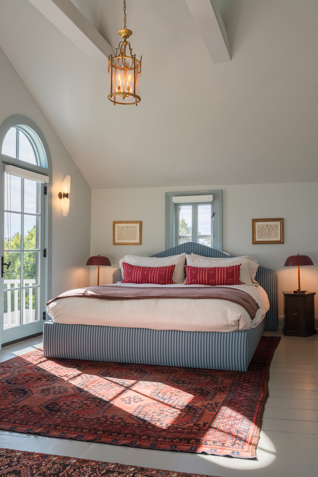 Primary bedroom with vaulted ceiling and lantern light