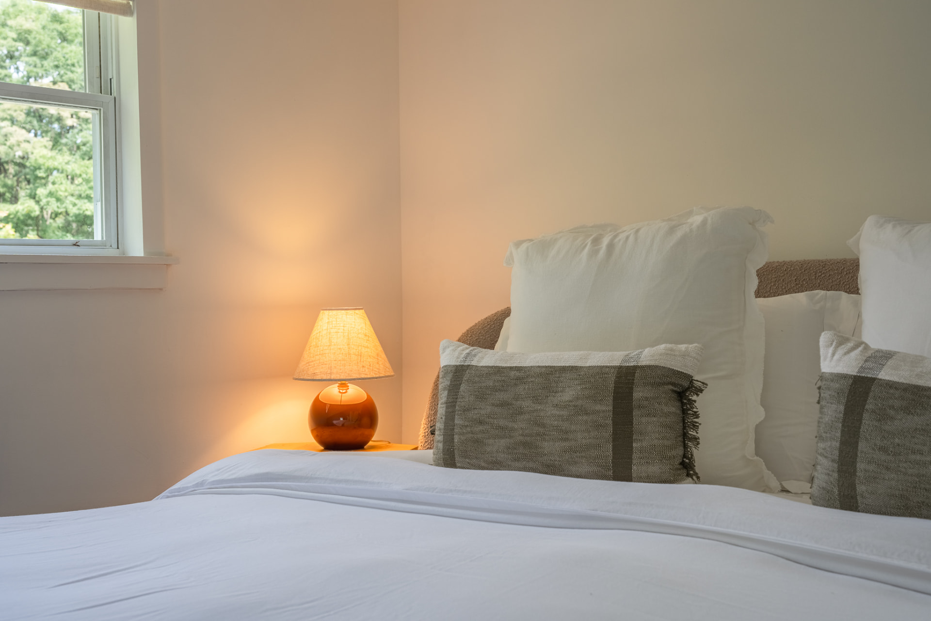Guest bedroom in soft evening lamplight