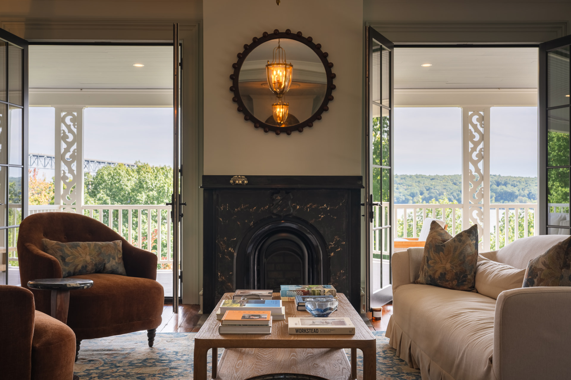Living room fireplace flanked by open french doors