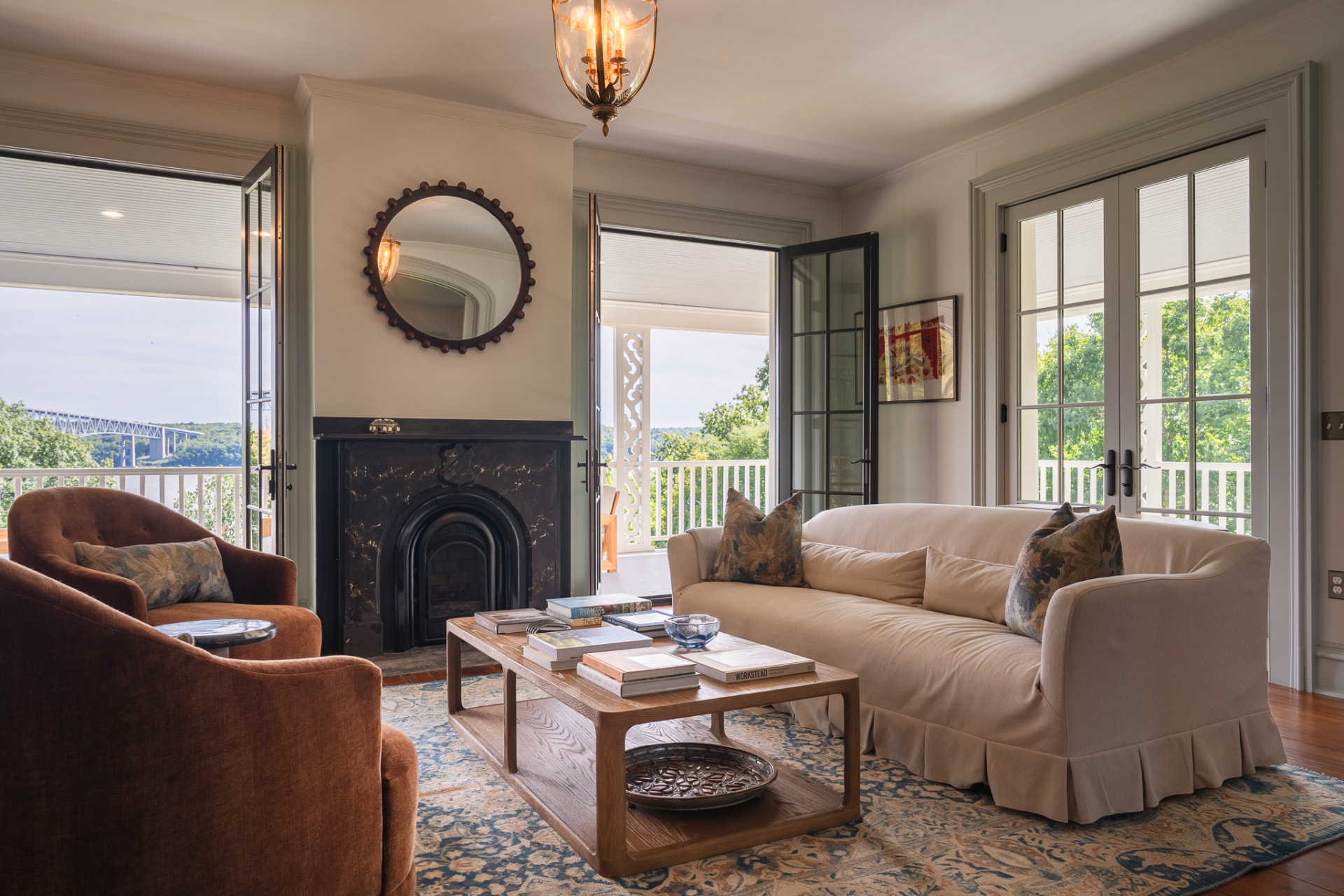 Main House living room with fireplace and river views
