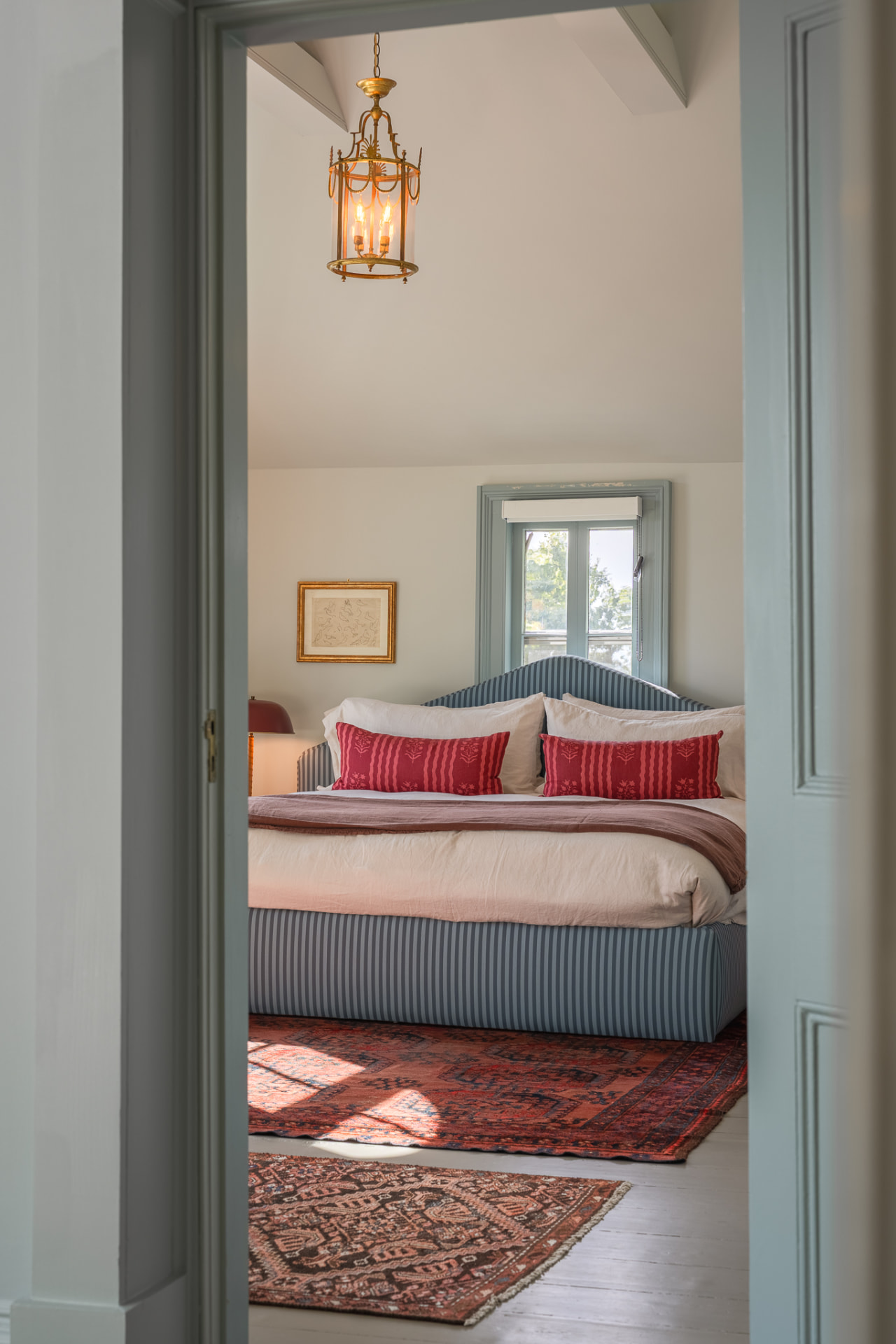 Bedroom seen through a pale blue doorway
