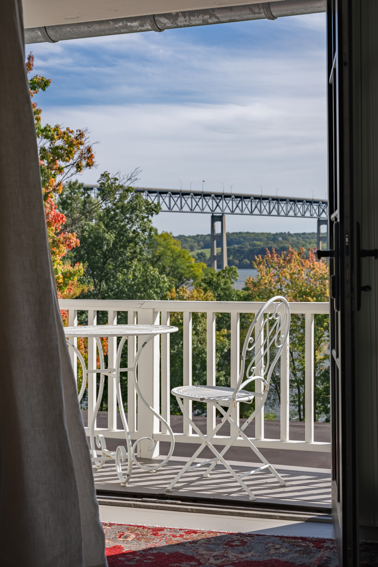 Bistro chairs on the porch overlooking the bridge