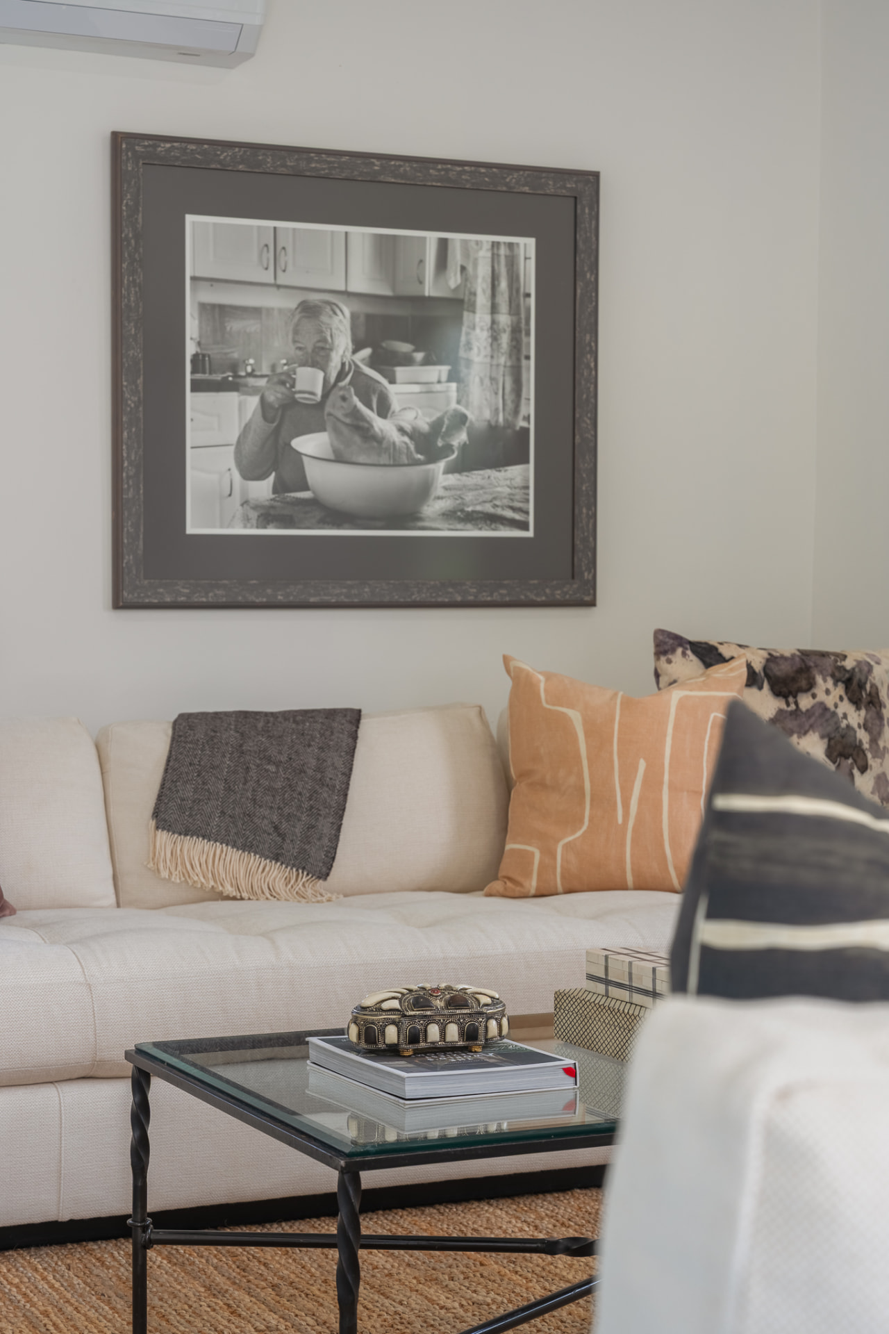 Gatehouse sitting area with sectional sofa and framed photograph