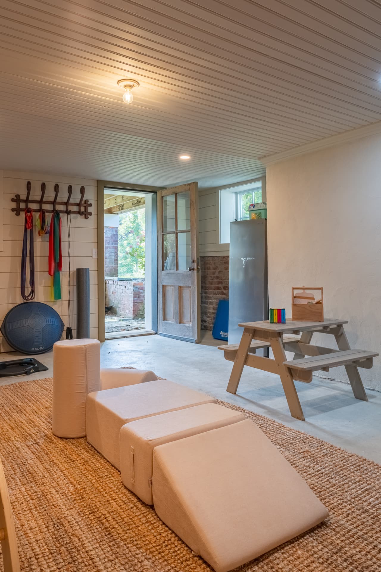 Garden-level play and workout room opening to the grounds