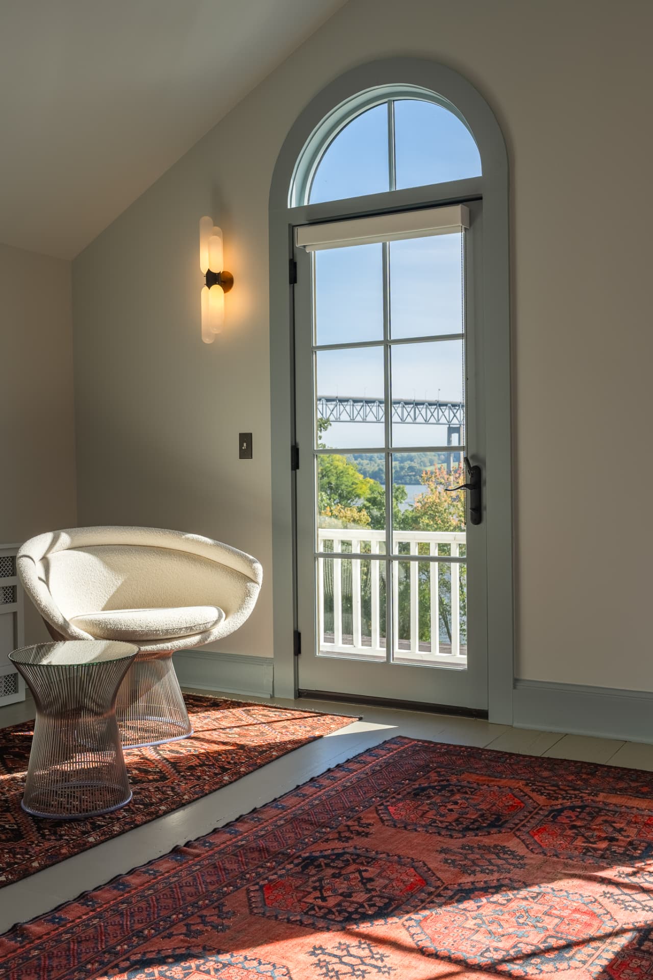 Reading corner by an arched glass door